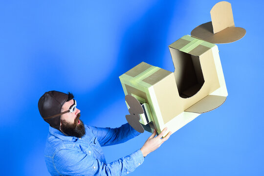 Man Holding Cardboard Plane In Hand. Isolated.