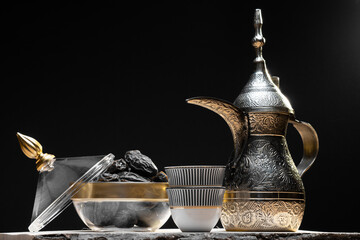 Eid and Ramadan set with Arabian coffee and dates set in dark background. Festive greeting card, an invitation for Muslim holy month Ramadan Kareem or Eid al Adha and Eid al fiter