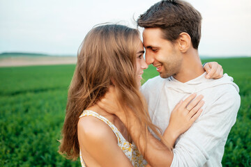 Beautiful young couple trying to kiss.