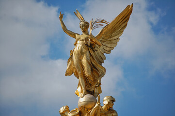 Fototapeta na wymiar Golden winged angel statue