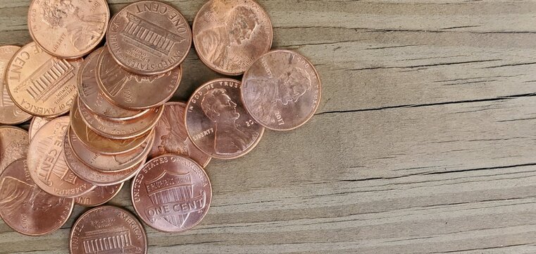 A bunch of old pennies on a wood background