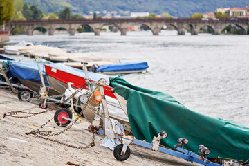 Docked boats on the lake Como district in Italy on sunny day. Alp mountains on background