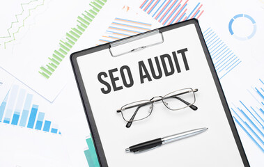 seo audit sign. Conceptual background with chart ,papers, pen and glasses
