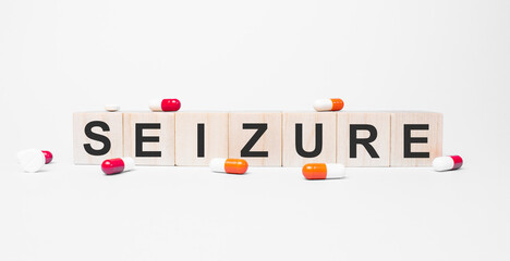 SEIZURE the word on wooden cubes, cubes stand on a reflective white surface. Medicine concept