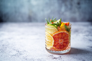 Red orange lime lemon cocktail in a glass