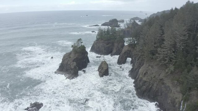 2020 - Excellent aerial shot of water cresting on coves of the Oregon coast on a foggy day.