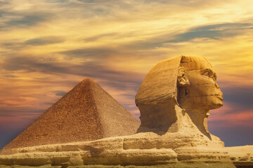 The Great Sphinx and Khafre Pyramid in Giza against colorful sunset sky in Giza, Cairo, Egypt