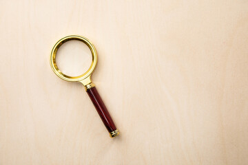 magnifying glass on wooden background