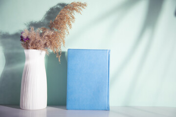 book with vase of grass