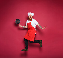 Man chef is scared for something. burgundy color background