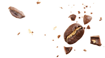Close-up of roasted beans flying in the air among ground coffee on white background. Concepts of levitation. The crash coffee shatters into pieces.