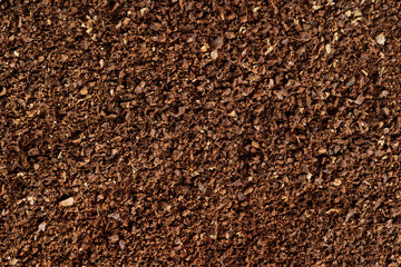 The texture of brown aromatic ground coffee. Macro view background with copyspace.