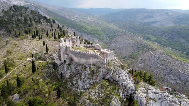 Aerial drone view of fortress fortress on a cliff. Old castle on the hill, view from above. Historic town Blagaj in Bosnia and Herzegovina. Stjepan-grad was built on a high, inaccessible karst hill. 