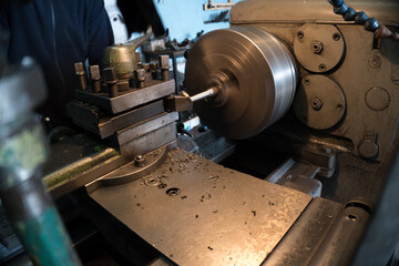 old lathe makes parts turner monitors the process