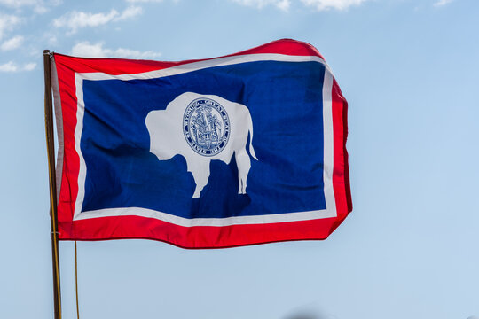 Wyoming State Flag with Bison and Great Seal flying in the wind