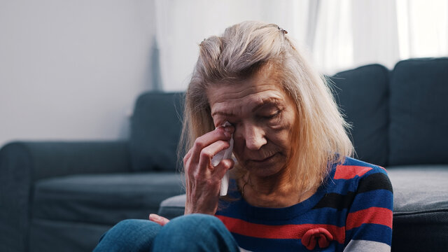 Lonely Elderly Woman Wiping Tears With Tissue. Loneliness At Old Age. High Quality Photo