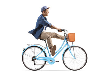 Full length profile shot of a guy riding a bicycle and lifitng legs