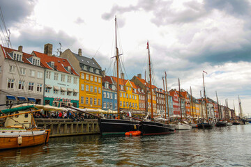 Fototapeta na wymiar View of the famous Nyhavn, Copenhagen, Denmark, with the canal and moored sailboats