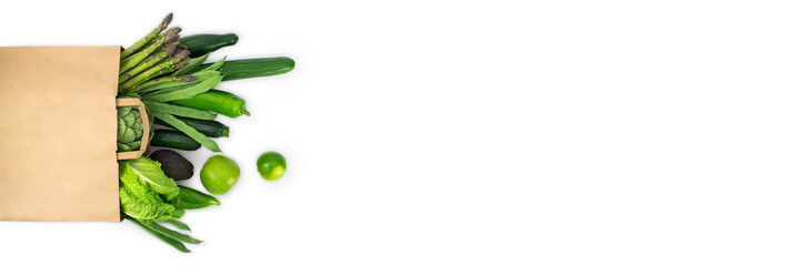 Banner of healthy food. Healthy food in paper bag, fresh green vegetables insolated on white. Shopping vegetarian food supermarket concept. Top view