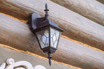 Black metal and glass vintage classic street lantern on blockhouse wall