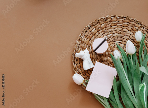 Greetings card, Spring composition. White tulips and candle on brown background. Mother day, 8 march. Blank greeting card. Flat Lay, Still life composition
