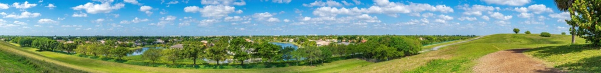 Fototapeta na wymiar Ultrawide panorama from a hilltop at Vista View Park - Davie, Florida, USA