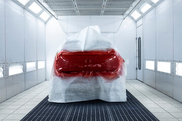 Freshly painted car vehicle in painting chamber workshop.