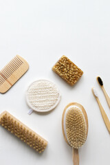 Bamboo toothbrushes, wood hairbrush, face wash, natural bristle brush and handmade oatmeal soap. Eco friendly stuff concept. Vertical orientation. Top view. Copy space.