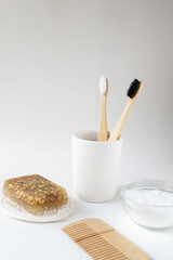 Wooden hair comb, face wash, handmade oatmeal soap, soda, bamboo toothbrushes. Bathroom set. Eco friendly stuff concept. Vertical orientation. Copy space.