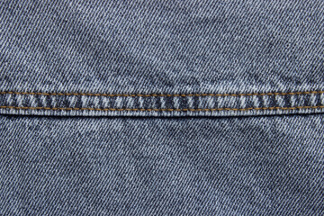 Jeans texture with seam. Blue jeans fabric plain surface background, denim textile texture