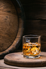 Whiskey in glass with ice is a strong alcoholic drink from an oak barrel. You need to drink whiskey with ice then the whiskey tastes better of an oak barrel.