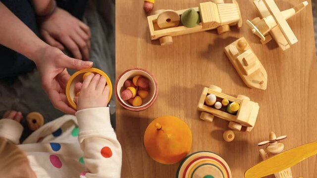 Variety of creative eco wooden toys for babies made of organic wood on table, untreated details or painted with eco-friendly paint. Non toxic natural craft supplies and materials for children play. 