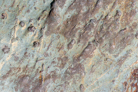 Stone rock background textured. Green stone background close-up in high resolution. Abstract background from natural stones close-up.