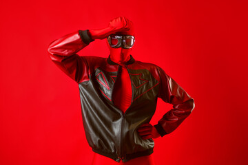 A funny super hero in a red leotard and protective glasses
