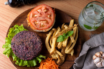 Homemade vegan and vegetarian hamburgers of legumes and vegetables with potatoes lettuce tomato on...