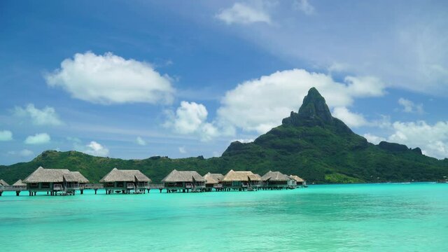 Bora Bora vacation paradise island with overwater bungalows resort hotel in coral reef lagoon ocean and beach. Mount Otemanu in background, Bora Bora, French Polynesia, Tahiti, South Pacific Ocean