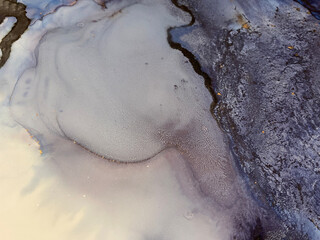 Abstract blue art with gold — fluid background with beautiful smudges and stains made with alcohol ink and golden pigment. Blue with violet texture resembles natural materials, watercolor or aquarelle