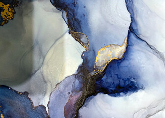 Abstract blue art with gold — fluid background with beautiful smudges and stains made with alcohol ink and golden pigment. Blue with violet texture resembles natural materials, watercolor or aquarelle