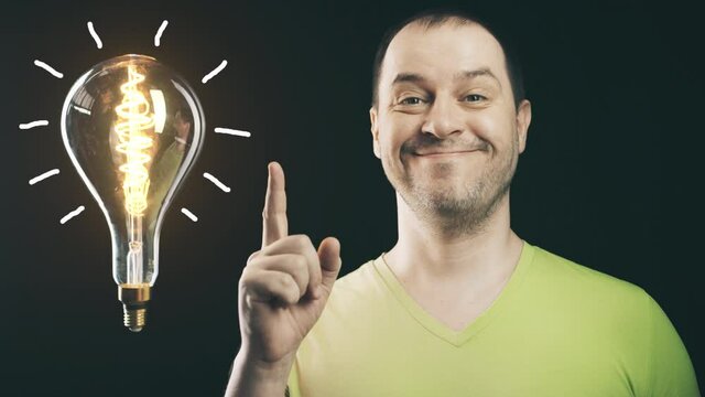 Cheerful man and big shining light bulb. Insight or idea concepts