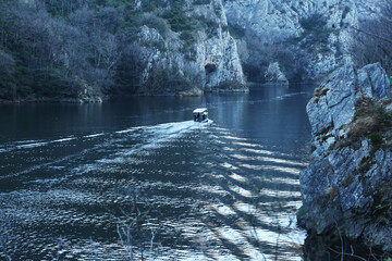 Boat goes by the river in Matka Canyon in Skopje, Macedonia. Matka is one of the most popular...