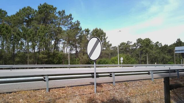 Esposende, Portugal - April 18, 2021: Road sign end of all restrictions on A28 highway indicating the Speed limit zone ends sign.
