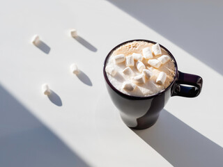 Top view on cup of cappuccino with marshmallow. Geometrical minimalist background with coffee mug....