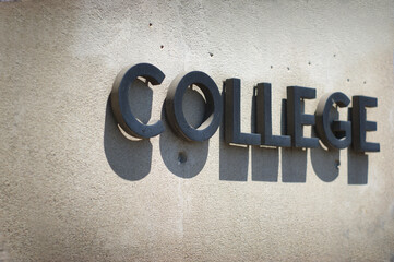 College sign on concrete wall with nice shadow