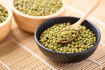 Mung bean seeds in a wooden spoon and bowl, Food ingredients in Asian cuisine and produce mung bean sprout