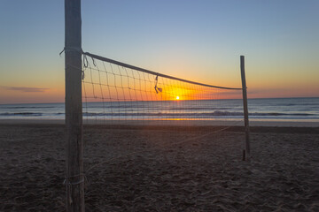 Fototapeta na wymiar Volleyball court without players at sunrise.