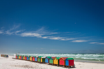 Fototapeta premium Famous colorful beach houses in Muizenberg near Cape Town, South Africa with Hottentots Holland mountains in the background.