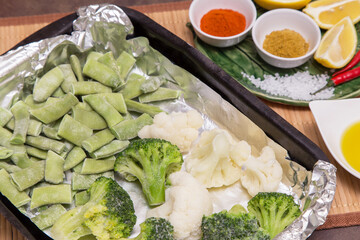 Frozen vegetables broccoli, string beans and cauliflower for cooking in foil in oven. Vegan vegetarian healthy diet asian food