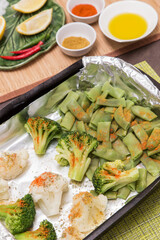 Baked in foil vegetables broccoli, green beans and cauliflower with spices and lemon. Vegan vegetarian healthy diet asian food