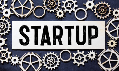 startup word written on wood block. startup text on table, concept.