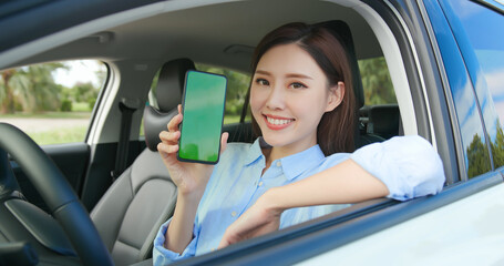 Asian female driver with smartphone